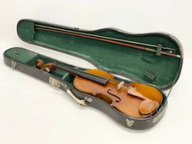 A vintage violin in case. Violin measures 61cm