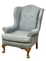 A large wingback armchair.
