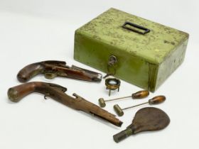 A sundry lot of military collectables. Including 2 19th century pistols, a powder flask with