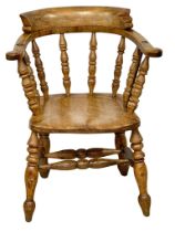 A Victorian Elm and Beech smokers armchair.