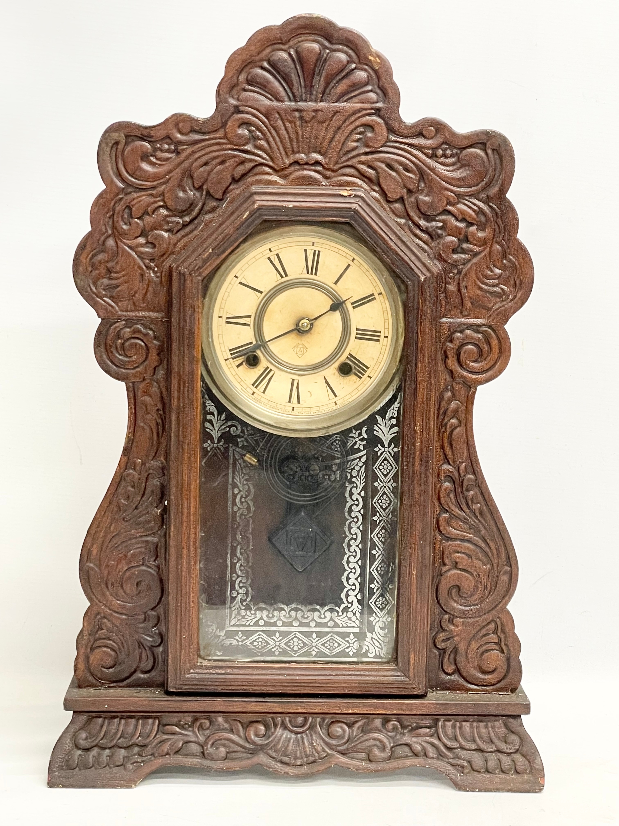 A late 19th century American Gingerbread clock. By Ansonia. With pendulum and 2 keys. 36x12x56.5cm