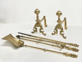 A set of good quality Victorian brass firedogs and tools. Tools measure 70cm