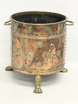A large Victorian copper and brass coal coal bucket on brass lion paw feet and lion head