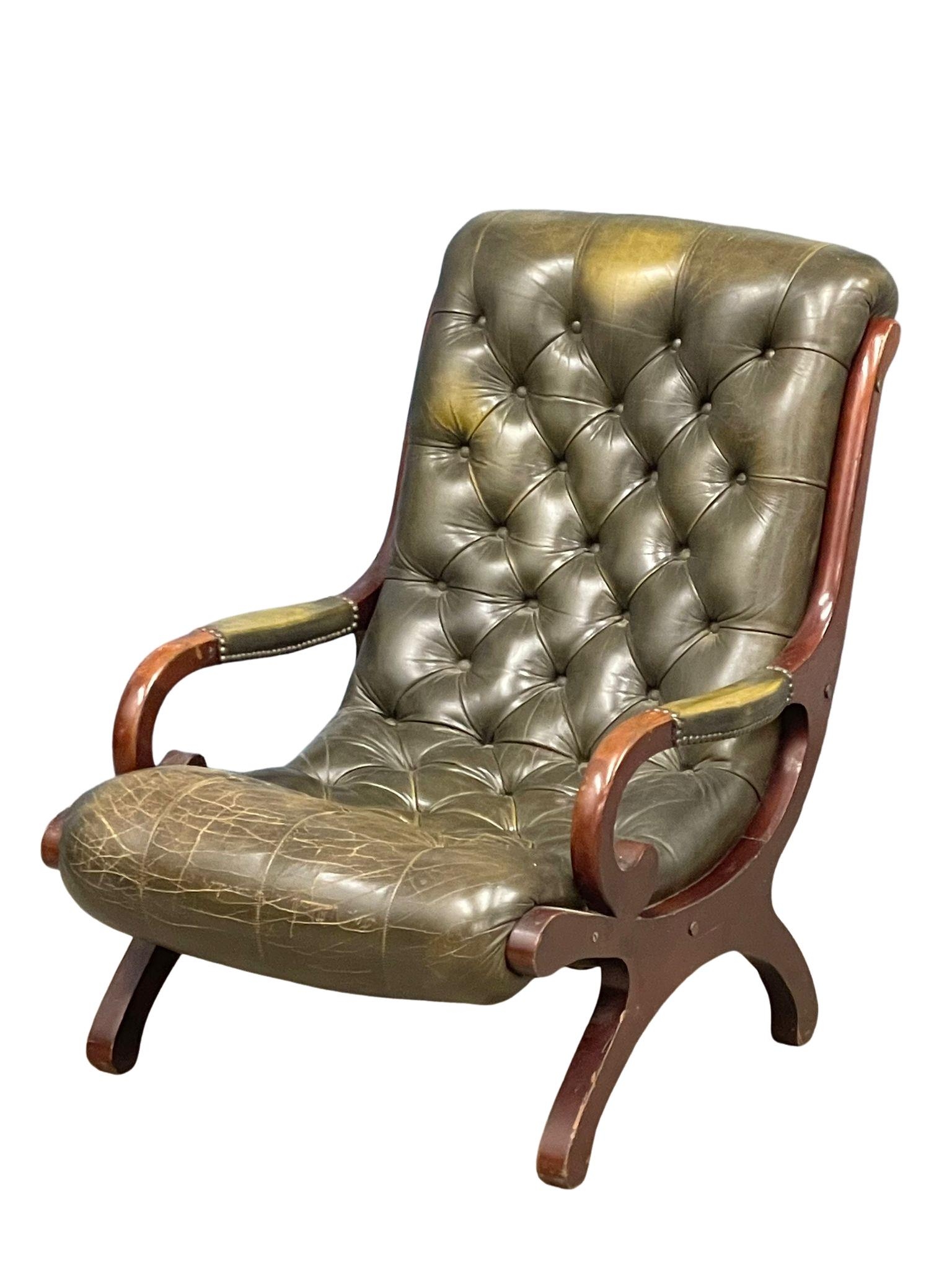 A Regency style deep button leather armchair.