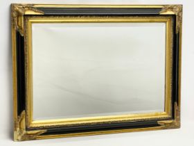 A large ornate gilt framed bevelled mirror. 94x69cm