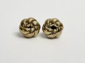 A pair of ladies 18ct gold swirl knot earrings. 2.60 grams.