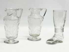 A pair of Victorian etched glass jugs and a Victorian etched glass drinking boot. 17cm