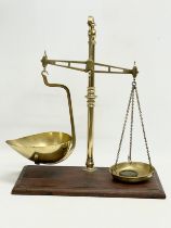 A late Victorian brass and oak balance scales. 41x22x49cm