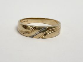 A 10k gold and diamond ring. 3.99 grams. Size R.