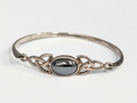 A silver bracelet / bangle.