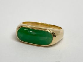 A 14k gold and jade ring. 3.29 grams. Size P.
