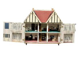 A large vintage dolls house and contents. 89x48x86cm