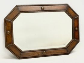 An early 20th century oak framed bevelled mirror. 69x47cm