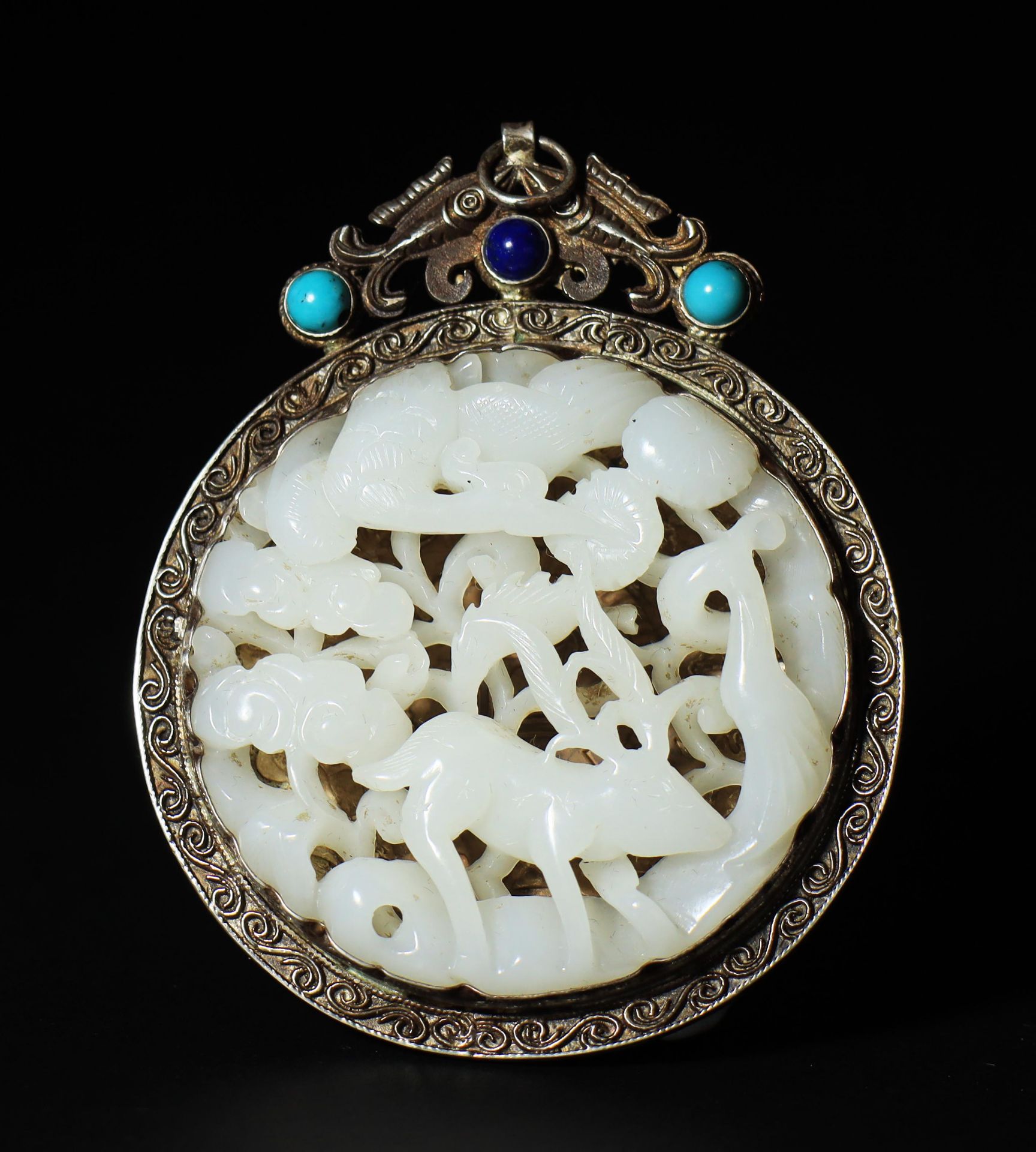 A silver-wrapped jade pendant from the Qing Dynasty