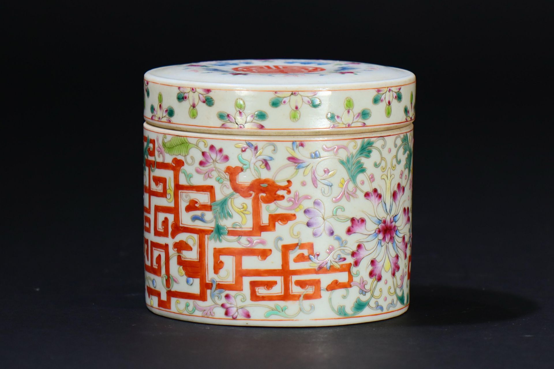 A famille rose porcelain lidded box decorated with deformed dragons and flowers, probably from