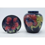 Moorcroft Anemone pin dish on blue background together with Hibiscus on blue ginger jar (missing
