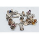 Silver charm bracelet with over 12 charms to include cars, lamps etc, 107.7 grams.