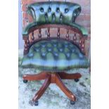 Chesterfield-style button back swivelling captains chair in green leather, 90cm tall. Leather is