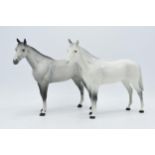 A pair of Beswick Bois Roussel horses to include gloss grey and matte grey (2). In good condition