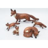 A collection of Beswick foxes to include large standing fox 1016, curled fox 1017, and 3 others (5).