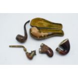 An interesting selection of pipes to include 2 with hallmarked silver collars, both Chester, one