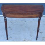 Early 19th century mahogany foldover demi-lune side table on turned legs and ebony stringing, with