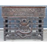 Antique Chinese carved alter table with folding legs with carved figural decoration with character