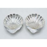 A near pair of hallmarked silver shell dishes, 64.3 grams, one Birmingham 1913 and the other