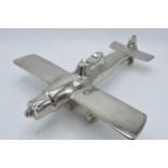 Vintage 20th century nickel-plated cast metal model of a plane with rotating wheels and propeller,