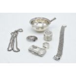 A collection of silver items to include a silver ladle, miniature purse / stamp case, chain and