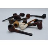 A collection of vintage smoking pipes and similar of varying forms to include makes such as Carey