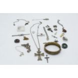 A collection of silver jewellery to include charms, gold on silver crucifix, brooches, chains and