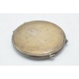 Hallmarked silver compact complete with mirror and powder, 7cm diameter, with engineered decoration,