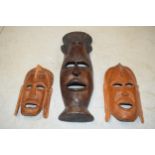 A trio of vintage tribal-style wooden face masks, 49cm tallest (3).