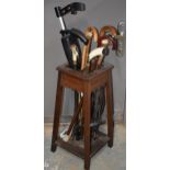 1930s wooden hall stick stand together with a range of walking sticks, to include country