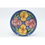 Moorcroft floral plate with bright coloured design, trial, 16cm diameter. In good condition with