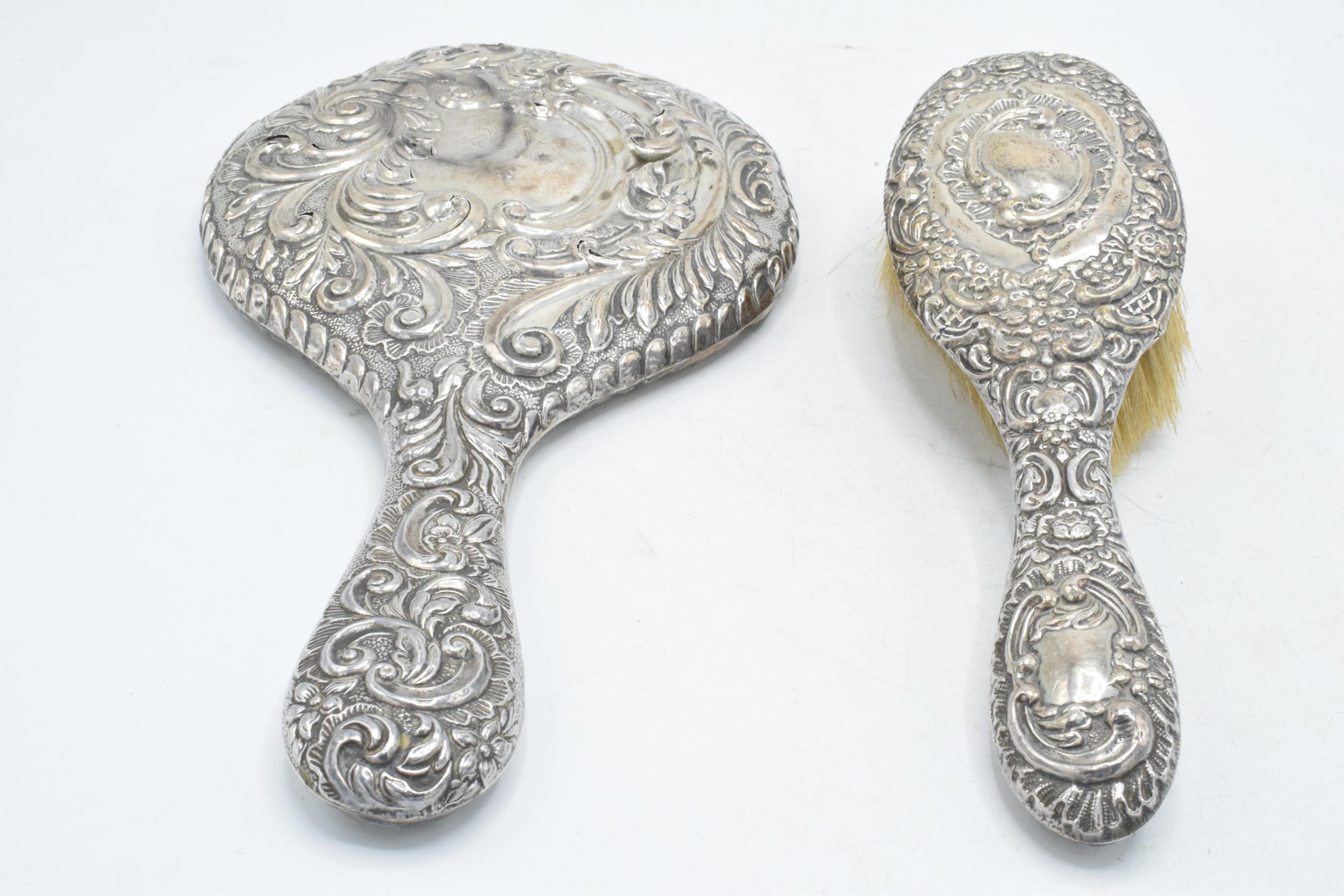 A hallmarked silver hand mirror, together with silver handled brush and other items to include