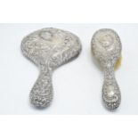 A hallmarked silver hand mirror, together with silver handled brush and other items to include