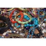 A large and varied collection of costume jewellery to include bangles, bracelets, necklaces, chain