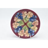 Moorcroft floral plate on maroon background, trial piece, 16cm diameter. In good condition with no