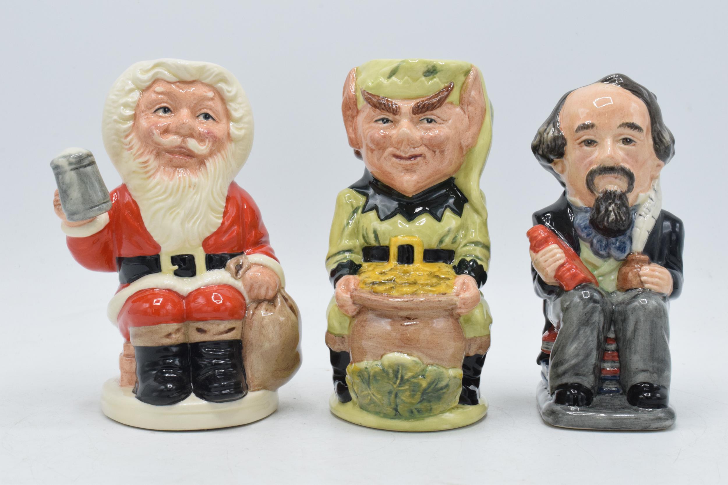 A trio of Royal Doulton Toby jugs to include Charles Dickens D6997, Leprechaun D6948 and Father