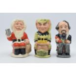 A trio of Royal Doulton Toby jugs to include Charles Dickens D6997, Leprechaun D6948 and Father