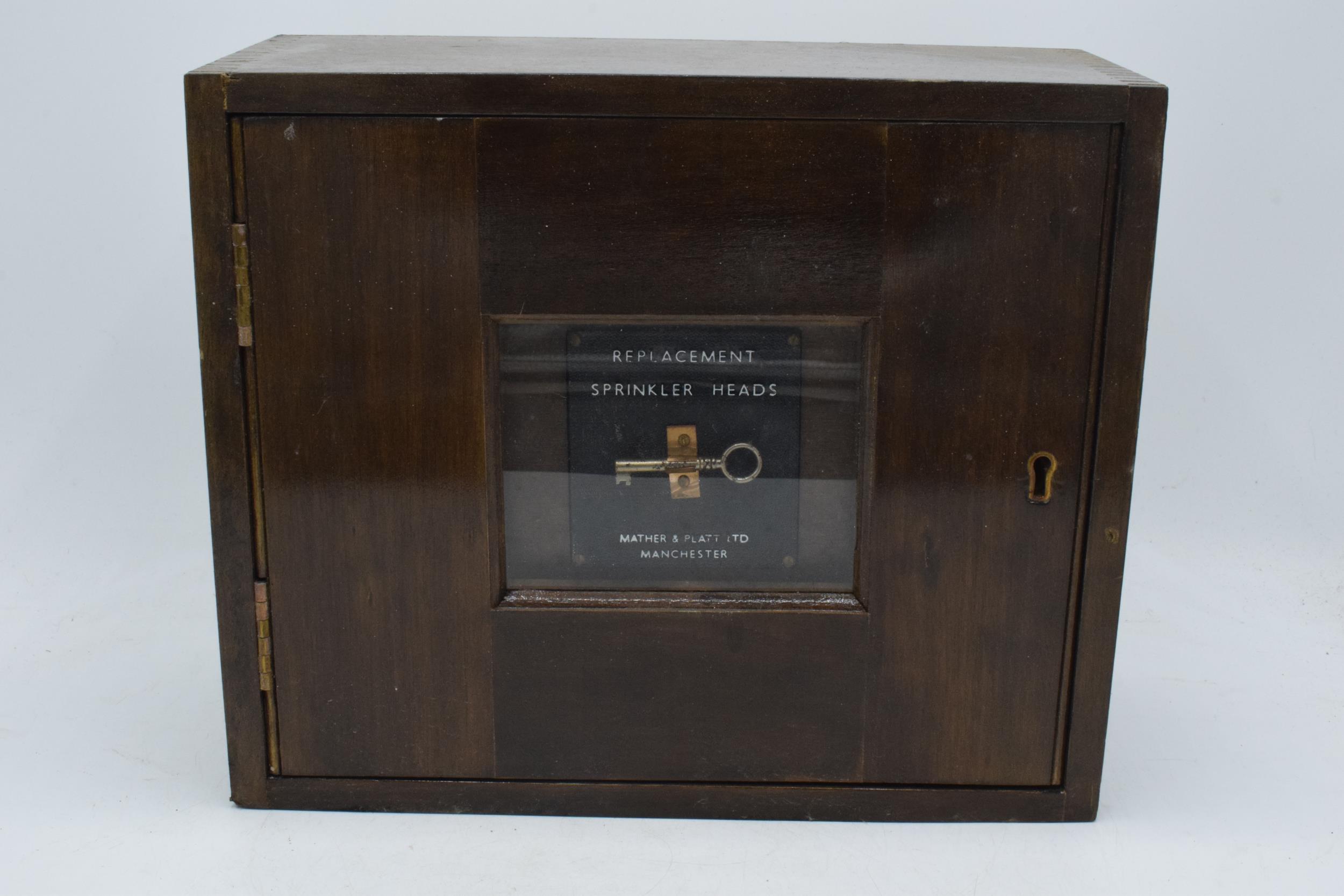 Vintage wooden cabinet, the centre panel enclosing a key 'Replacement Sprinkler Heads' by Mather &