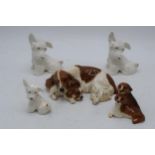 A collection of Beswick and Royal Doulton dogs to include Sealyham Terriers, Beagles and lying