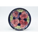 Moorcroft floral plate on deep blue background, trial piece, 16cm diameter. In good condition with