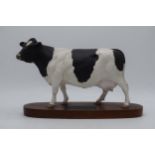Beswick Friesian Cow Connoisseur model on wooden base A2607 (left ear chipped). Ear damaged