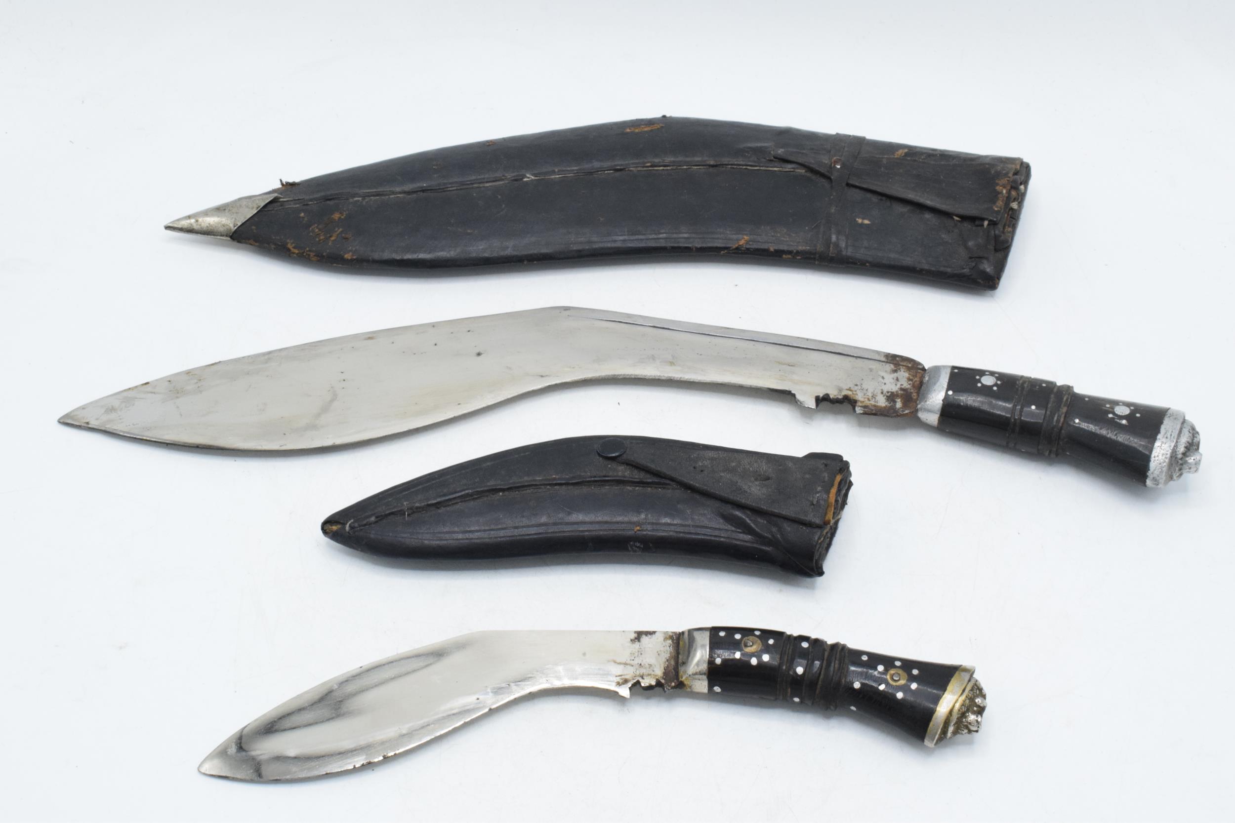 20th century Gurkha style Kukri knife in black leather scabbard together with smaller example (2),