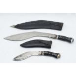 20th century Gurkha style Kukri knife in black leather scabbard together with smaller example (2),