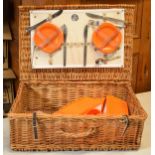 Retro orange picnic set in wicker basket by St Christopher with some contents. Not checked for