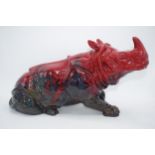 Large Royal Doulton veined flambe model of a seated rhino, 42cm long. In good condition with no
